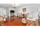 Living room featuring hardwood floors, ornate furniture, a large television and access to the front door at 4417 Barharbor Ct, Indianapolis, IN 46268