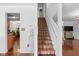 Bright staircase with wood treads, white risers, and stylish decor at 4417 Barharbor Ct, Indianapolis, IN 46268
