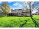 Spacious backyard with large lawn, mature trees, and outdoor amenities creating an inviting outdoor oasis at 4606 Sundance Trl, Indianapolis, IN 46239