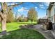 Beautiful backyard featuring a deck, fire pit, and landscaped areas for relaxation and entertaining at 4606 Sundance Trl, Indianapolis, IN 46239