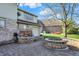 Beautiful backyard featuring brick pavers, tiered brick planter, and two charming round fire pits at 4606 Sundance Trl, Indianapolis, IN 46239