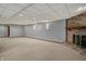 Spacious carpeted basement featuring a brick fireplace and neutral wall paint at 4606 Sundance Trl, Indianapolis, IN 46239