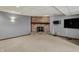Cozy basement featuring a brick fireplace and a large TV at 4606 Sundance Trl, Indianapolis, IN 46239