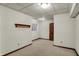 Spacious basement with neutral carpet, trim, and a wooden shelf to provide extra storage at 4606 Sundance Trl, Indianapolis, IN 46239