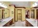 Bathroom with double sink vanity, wood trim, and ample storage at 4606 Sundance Trl, Indianapolis, IN 46239