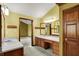 Bathroom featuring double sink vanity, wood trim, and plenty of counter space at 4606 Sundance Trl, Indianapolis, IN 46239