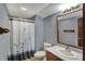 Bathroom features a shower with curtain, toilet and vanity with mirror at 4606 Sundance Trl, Indianapolis, IN 46239