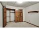 Bedroom with beige carpet and natural wood closet doors, and a decorative wood shelf at 4606 Sundance Trl, Indianapolis, IN 46239