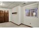Bedroom with wood trim, beige carpet, wood closet doors, and small window at 4606 Sundance Trl, Indianapolis, IN 46239