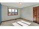 Bright bedroom features neutral walls, carpet flooring, a window view, and wood trim accents at 4606 Sundance Trl, Indianapolis, IN 46239