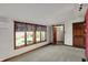 Bright bedroom featuring three windows with a view, a closet, and carpet flooring at 4606 Sundance Trl, Indianapolis, IN 46239