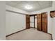 Carpeted bedroom features natural wood closet doors and trim in neutral colors at 4606 Sundance Trl, Indianapolis, IN 46239