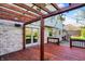 Outdoor deck showcasing a wood pergola, string lights, and access to the home through sliding glass doors at 4606 Sundance Trl, Indianapolis, IN 46239