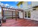 Outdoor deck featuring wood pergola, lattice, string lights, and a built-in bench for relaxing and entertaining at 4606 Sundance Trl, Indianapolis, IN 46239