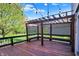 Wood deck with pergola, built-in bench, and string lights creates a cozy and inviting outdoor space at 4606 Sundance Trl, Indianapolis, IN 46239