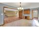 Open floorplan of the dining room with wood cabinets and a view of the brick fireplace at 4606 Sundance Trl, Indianapolis, IN 46239