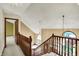 Bright hallway with wooden railing, high ceilings, and views of the home's elegant interior design at 4606 Sundance Trl, Indianapolis, IN 46239