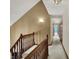 Carpeted hallway with wooden railing leading to bedrooms, offering a seamless transition between spaces at 4606 Sundance Trl, Indianapolis, IN 46239