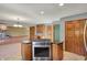 Kitchen island with stainless steel oven and cooktop with view to living room fireplace at 4606 Sundance Trl, Indianapolis, IN 46239