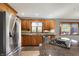 Eat-in kitchen with stainless steel appliances, hardwood cabinets, and a view of the backyard at 4606 Sundance Trl, Indianapolis, IN 46239