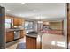 Kitchen island with stovetop, stainless steel appliances, and an open view to living room at 4606 Sundance Trl, Indianapolis, IN 46239