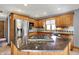 Kitchen with granite counters, stainless steel appliances, and hardwood cabinets at 4606 Sundance Trl, Indianapolis, IN 46239
