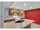 Close up of the basement kitchenette with island sink, white stove and wood cabinets at 4606 Sundance Trl, Indianapolis, IN 46239