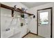 Functional laundry room with utility sink, shelving, and a door leading to the outdoors at 4606 Sundance Trl, Indianapolis, IN 46239