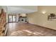 Large living room with hardwood floors, a stone fireplace, and french doors leading to the backyard at 4606 Sundance Trl, Indianapolis, IN 46239