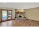 Spacious living room features hardwood floors, brick fireplace, and sliding doors to a wooden deck at 4606 Sundance Trl, Indianapolis, IN 46239