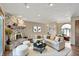 Comfortable living room showcasing a stone fireplace, hardwood floors, and ample natural light at 4606 Sundance Trl, Indianapolis, IN 46239