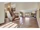 Open-concept living room with hardwood floors, a staircase, and lots of natural light at 4606 Sundance Trl, Indianapolis, IN 46239