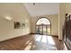 Bright living room featuring hardwood floors and an expansive arched window that lets in lots of sunlight at 4606 Sundance Trl, Indianapolis, IN 46239