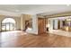 Open-concept living room with hardwood floors, a staircase, and a view into the kitchen area at 4606 Sundance Trl, Indianapolis, IN 46239