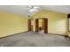 Spacious primary bedroom featuring vaulted ceilings, carpet, and double doors to en-suite bathroom and closet at 4606 Sundance Trl, Indianapolis, IN 46239