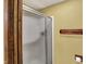 Close-up of bathroom shower with glass doors and wood accents at 4606 Sundance Trl, Indianapolis, IN 46239