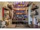 Home bar featuring a wide assortment of spirits, glassware, and built-in lighting at 5875 Annanhill Ct, Avon, IN 46123
