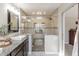 Bathroom featuring an elegant tiled shower with glass enclosure, rainfall shower head and granite countertop at 5875 Annanhill Ct, Avon, IN 46123
