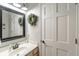Well-lit bathroom featuring a decorative mirror and white vanity at 5875 Annanhill Ct, Avon, IN 46123