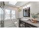 Bright bathroom featuring a large window, modern vanity, and stylish decor at 5875 Annanhill Ct, Avon, IN 46123