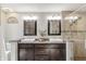 Stylish bathroom features a double vanity, granite countertop and tiled shower with glass door at 5875 Annanhill Ct, Avon, IN 46123