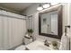 Well-lit bathroom featuring a decorative mirror, vanity with sink, and a shower with a curtain at 5875 Annanhill Ct, Avon, IN 46123