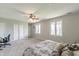 Bright bedroom with neutral carpet, featuring two large windows and a closet with sliding doors at 5875 Annanhill Ct, Avon, IN 46123