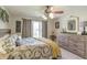 Cozy bedroom featuring a ceiling fan, neutral walls, and a dresser at 5875 Annanhill Ct, Avon, IN 46123