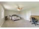 Spacious bedroom with neutral carpet and paint, featuring a ceiling fan and a large window at 5875 Annanhill Ct, Avon, IN 46123