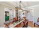 Dining room featuring hardwood floors, decorative lighting, and a view into the adjacent entryway at 5875 Annanhill Ct, Avon, IN 46123