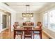 Formal dining room with hardwood floors, stylish chandelier, and elegant decor for Gathering gatherings at 5875 Annanhill Ct, Avon, IN 46123