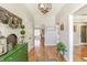 Welcoming entryway with hardwood floors, decorative accents, and a charming rustic chandelier overhead at 5875 Annanhill Ct, Avon, IN 46123