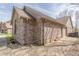 Side exterior showcasing brickwork and attached garage with a well-manicured landscape at 5875 Annanhill Ct, Avon, IN 46123