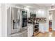 Bright kitchen features stainless steel refrigerator, a double oven and granite countertops at 5875 Annanhill Ct, Avon, IN 46123
